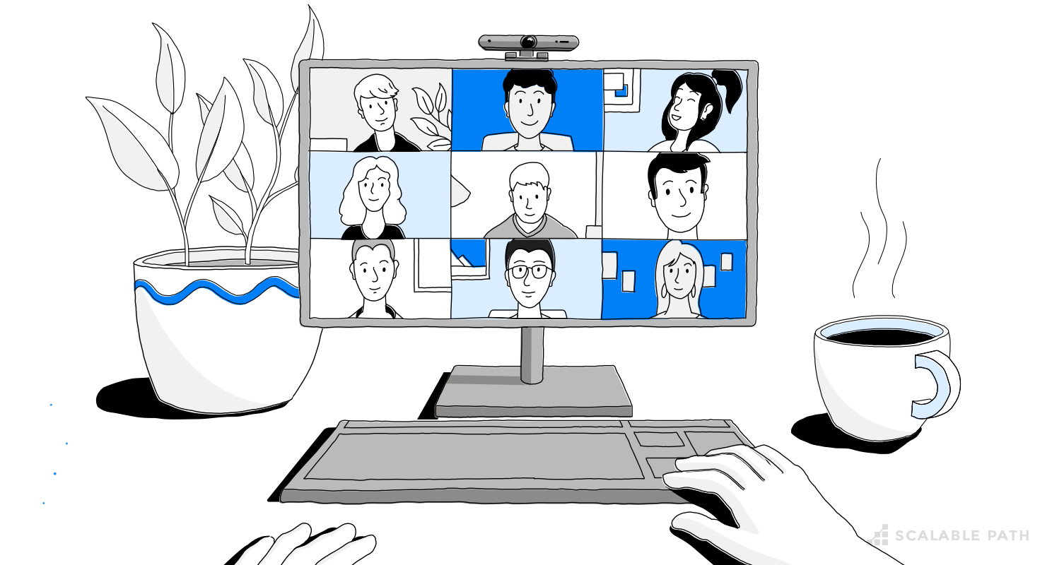 A computer in a desktop with a remote team connected in a video call
